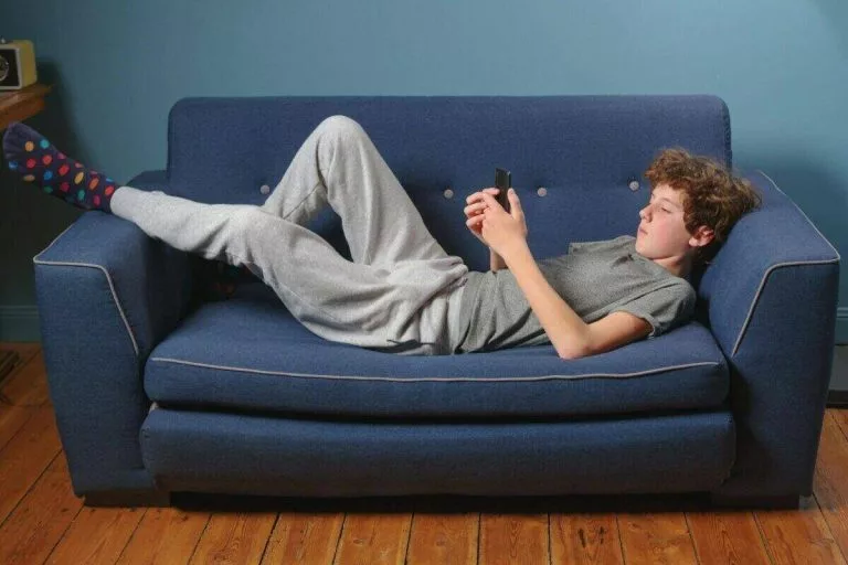 kid on phone on couch